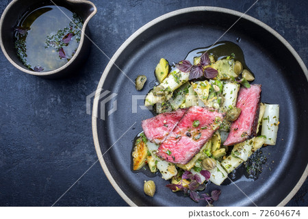 dry aged sliced filet steak with asparagus potato salad 72604674