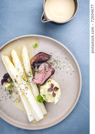 barbecue dry aged sliced fillet steak with white asparagus in butter sauce and mashed potatoes  72604677