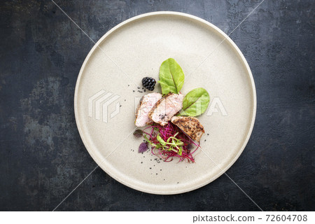 Traditional fried pork fillet with salad and fruits  72604708