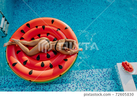 Pool Float woman relax in swimming pool on summer vacations Pool Float woman relax in swimming pool on summer vacations 72605830