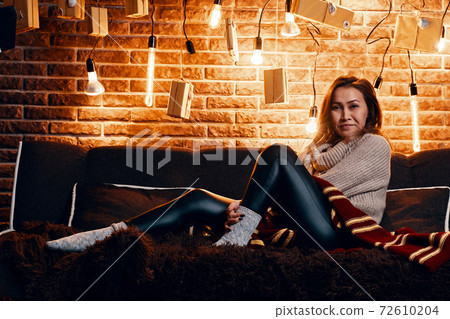 Cute girl sitting on the couch. 72610204