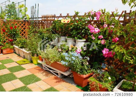 Outdoor living room with roof balcony in flower garden Outdoor living room with roof balcony in flower garden 72610980