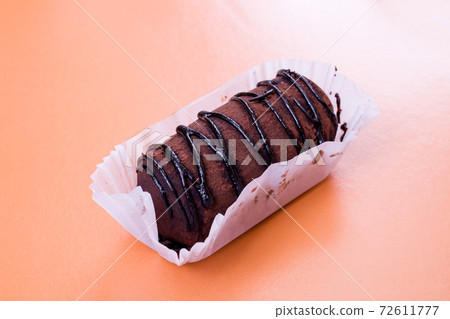 Chocolate cake with cream on red background closeup 72611777