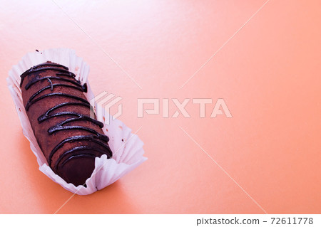 Chocolate cake with cream on red background closeup Chocolate cake with cream on red background closeup 72611778
