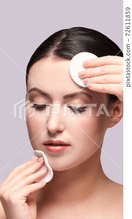 Girl remove mascara. Cotton pad. Skin care evening routine 72611859