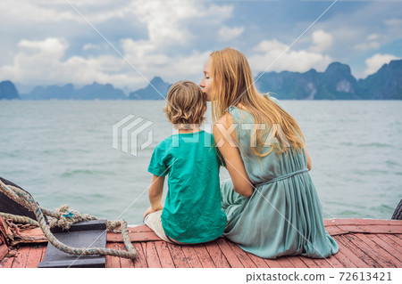 Mom and son travelers is traveling by boat in Halong Bay. Vietnam. Travel to Asia, happiness emotion, summer holiday concept. Traveling with children concept. After COVID 19. Picturesque sea landscape 72613421