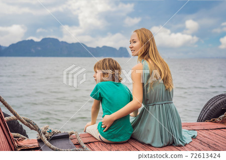 Mom and son travelers is traveling by boat in Halong Bay. Vietnam. Travel to Asia, happiness emotion, summer holiday concept. Traveling with children concept. After COVID 19. Picturesque sea landscape 72613424