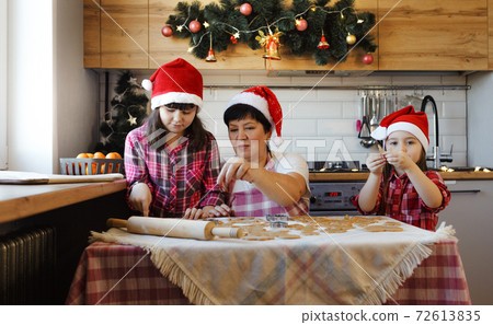 the family is preparing for the new year and preparing cookies 72613835