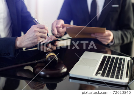 Teamwork of business lawyer meeting working hard about legal legislation in courtroom to help their customer. Teamwork of business lawyer meeting working hard about legal legislation in courtroom to help their customer. 72613840