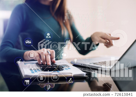 Businessman working on calculator to calculate financial data report, accountancy document and laptop computer at office, business concept. 72613841