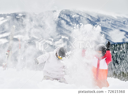 Friends skiers having fun at ski resort in the mountains in winter, skiing and snowboarding Friends skiers having fun at ski resort in the mountains in winter, skiing and snowboarding 72615368