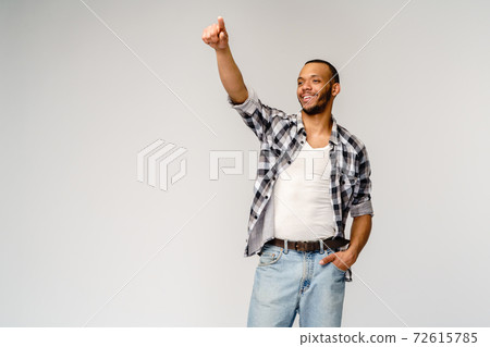 Young african american man pressing or pushing button on virtual screen 72615785