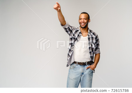 Young african american man pressing or pushing button on virtual screen Young african american man pressing or pushing button on virtual screen 72615786