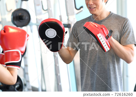 Male trainer holding a mitt Male trainer holding a mitt 72616260