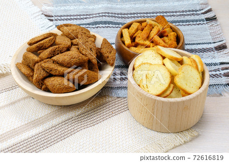 fried croutons close-up three types of crackers white, black, brown. 72616819
