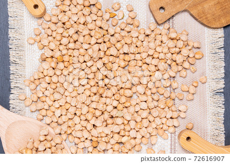 Raw chickpeas in bowl on a dark background. A view from above, a copy of space Raw chickpeas in bowl on a dark background. A view from above, a copy of space 72616907