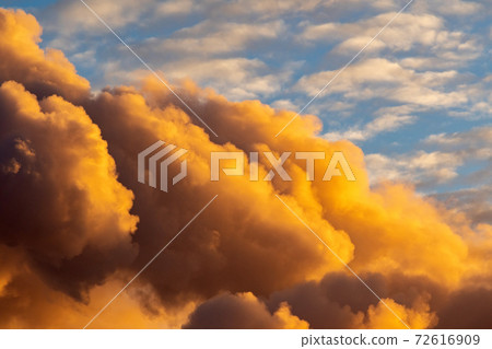 yellow smoke against the sky. black smoke from burning forest trees and buildings against the blue sky. yellow smoke against the sky. black smoke from burning forest trees and buildings against the blue sky. 72616909