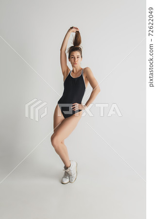 Beautiful young woman's portrait isolated on grey studio background. Having fun, happy, full length Beautiful young woman's portrait isolated on grey studio background. Having fun, happy, full length 72622049