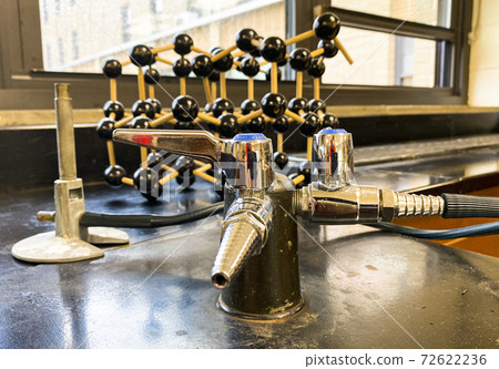 Bunsen burner on black lab desk in high school classroom Bunsen burner on black lab desk in high school classroom 72622236