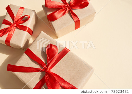 Presents with red ribbon on the bright background .,, Presents with red ribbon on the bright background .,, 72623481