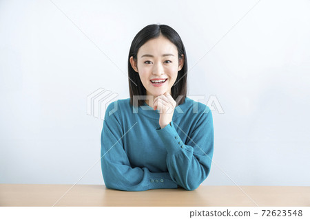A woman in her early twenties looking at the camera A woman in her early twenties looking at the camera 72623548