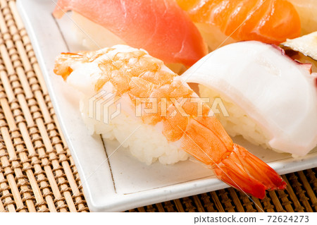 A nigiri sushi platter with a focus on shrimp and nigiri. 72624273