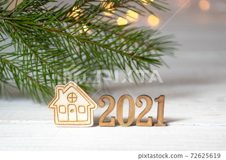 New Year composition with the numbers 2021 and a small house on 72625619