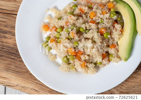 Close-up Quinoa porridge with vegetables and avocado in a white flat 72625621