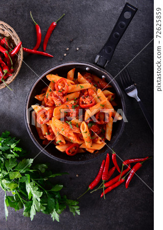 Penne pasta with chili sauce arrabiata 72625859