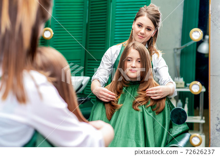 Hairdresser makes hairstyle. Hairdresser makes hairstyle. 72626237