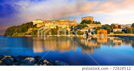 travel in Italy - picturesque tranquil Capodimonte village in lake Bolsena over sunset. 72626512