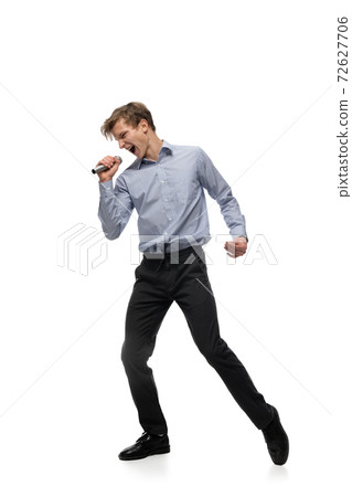 Happy young man dancing in casual clothes or suit, remaking legendary moves of celebrity from culture history Happy young man dancing in casual clothes or suit, remaking legendary moves of celebrity from culture history 72627706