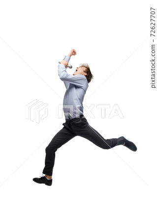 Happy young man dancing in casual clothes or suit, remaking legendary moves of celebrity from culture history Happy young man dancing in casual clothes or suit, remaking legendary moves of celebrity from culture history 72627707
