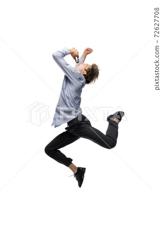 Happy young man dancing in casual clothes or suit, remaking legendary moves of celebrity from culture history Happy young man dancing in casual clothes or suit, remaking legendary moves of celebrity from culture history 72627708