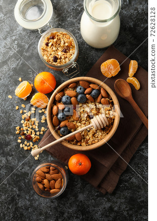 Concept of tasty breakfast with granola on black smokey background Concept of tasty breakfast with granola on black smokey background 72628128