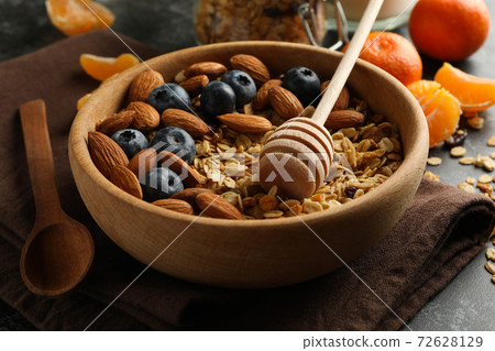 Concept of tasty breakfast with granola on black smokey background Concept of tasty breakfast with granola on black smokey background 72628129