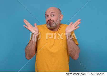 Doubtful man feel at loss lift hands in confusion unsure about problem. Doubtful man feel at loss lift hands in confusion unsure about problem. 72628294