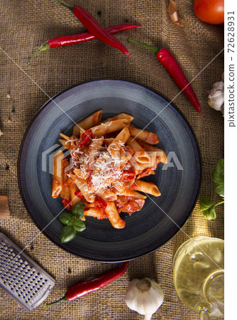 Penne pasta with chili sauce arrabiata 72628931