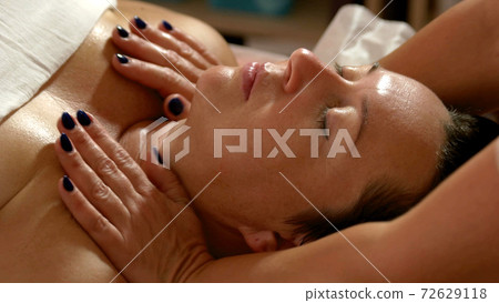 Relaxed woman having body massage at spa salon. 72629118
