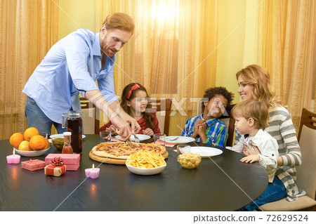 Family at the dining table. 72629524