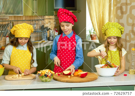 Three kids cooking. Three kids cooking. 72629757