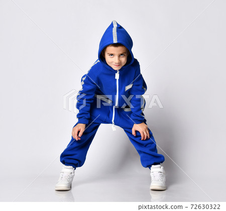 Cheerful playful boy in a blue sports trendy warm 72630322