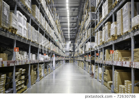 Huge distribution warehouse with high shelves and loaders. 72630786
