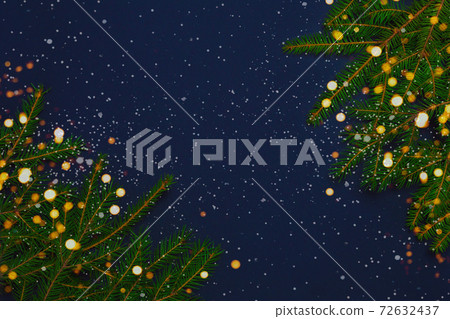 Snowy fir tree branches on blue background Snowy fir tree branches on blue background 72632437