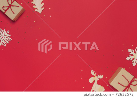 Craft present with baubles on red background 72632572