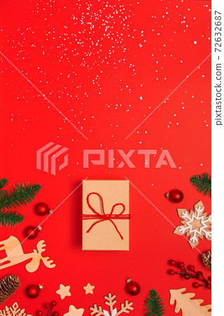 Beautiful craft Christmas present on red background 72632687