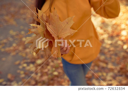 Woman walking and having fun outdoors in autumn time. Woman walking and having fun outdoors in autumn time. 72632834