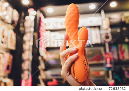 450px x 318px - Girl's hand holds a pink massager for sex.... - Stock Photo [72632982] -  PIXTA