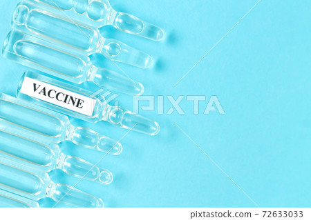 Glass medical vials with liquid. Ampoules with coronavirus vaccine 72633033