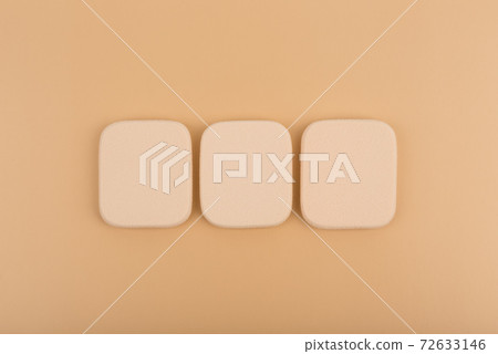 Flat lay with make up sponges on beige background 72633146